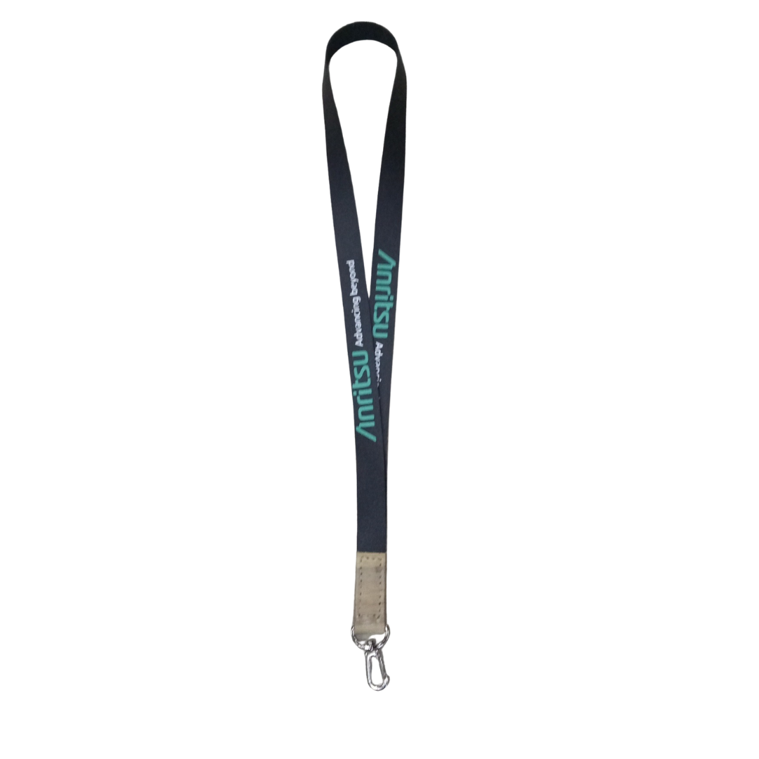 Custom black Anritsu logo lanyard for ID badges and corporate events, with green text and a durable metal clip, featuring green "Anritsu Advancing Beyond" text, a light brown faux vegan leather accent, and a silver swivel clip, hanging vertically.