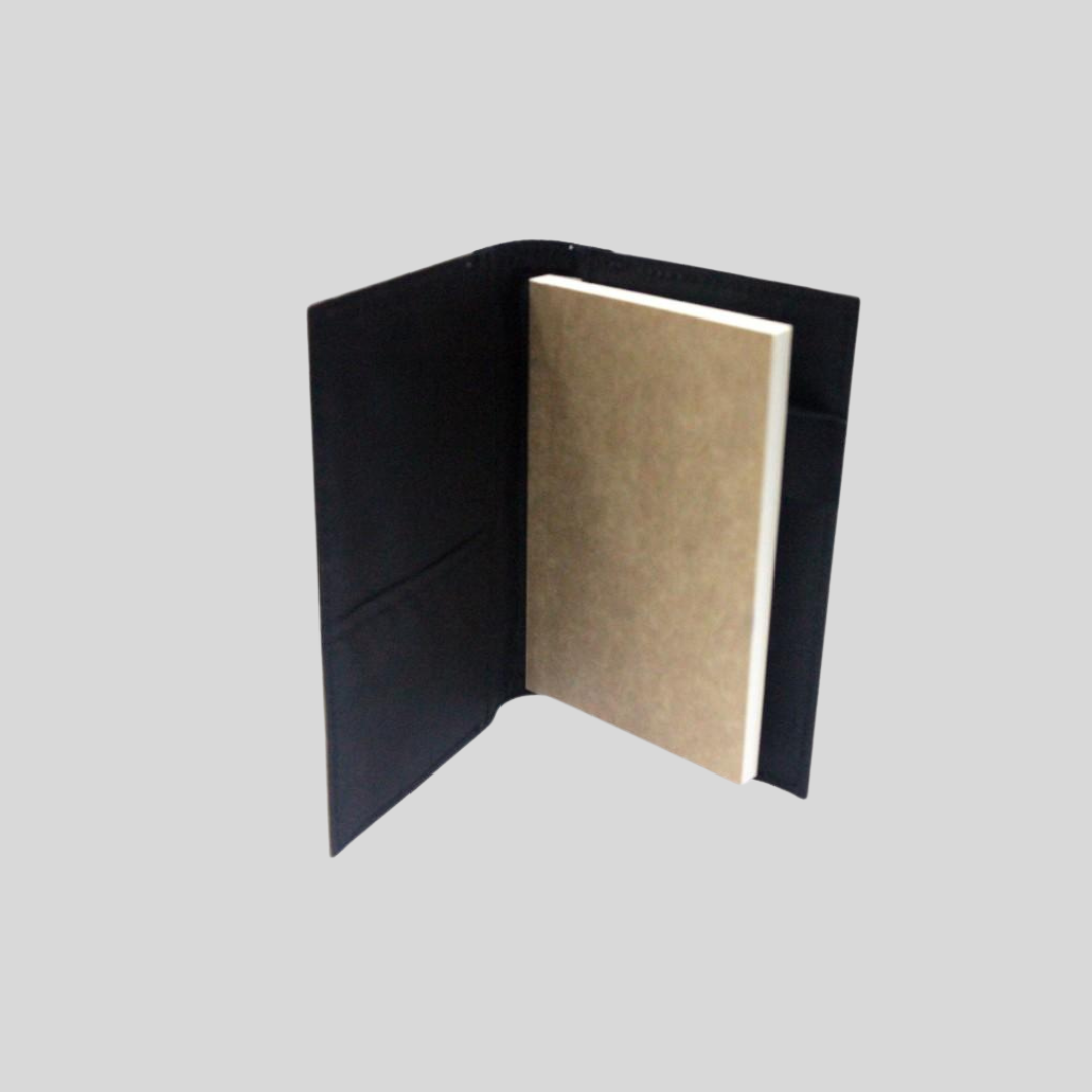 An upright standing black notebook with its pages unopened.