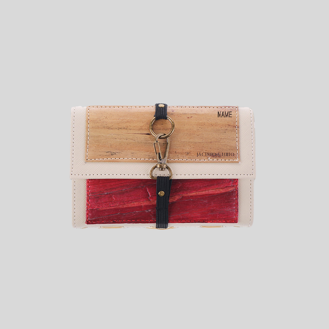 A small wallet made of vegan leather with a metal hook for closure in its center.
