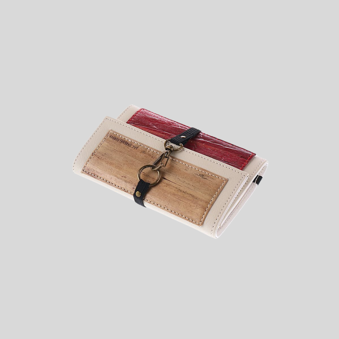 A tri-color vegan leather wallet with a brown flap and a red flap.