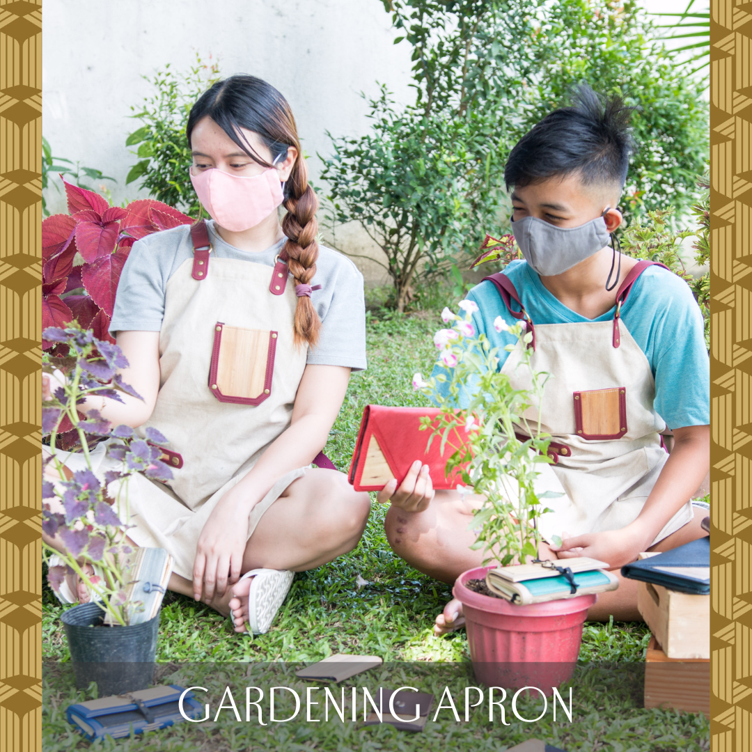 A girl and a boy wearing cream colored aprons made out of recycled material and vegan leather whilst gardening and planting plants.