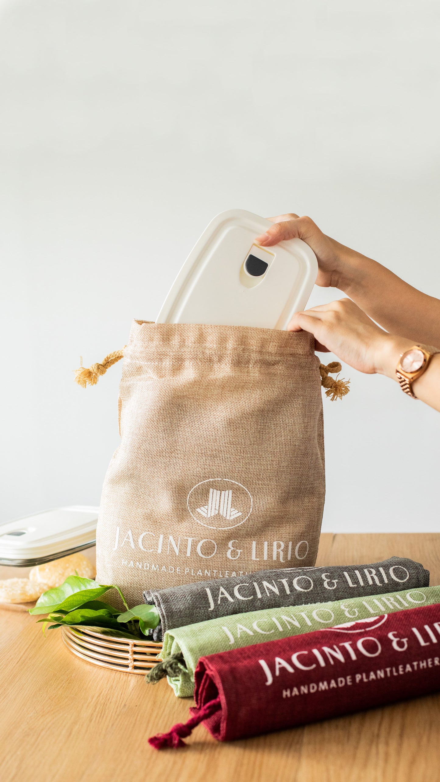 A white plastic container being stored inside a beige drawstring bag.