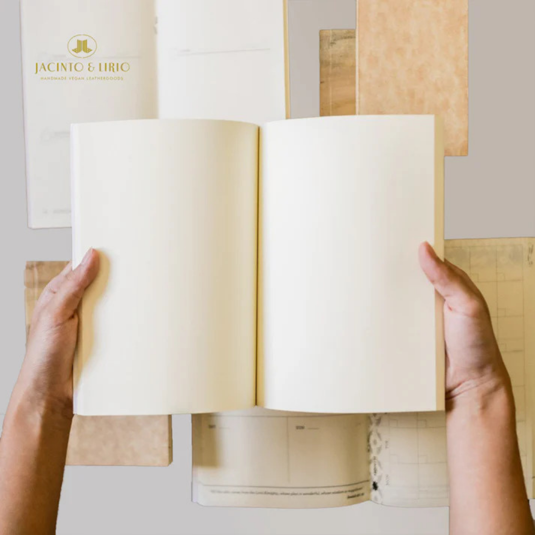 Two hands holding up a blank notebook with cream pages.