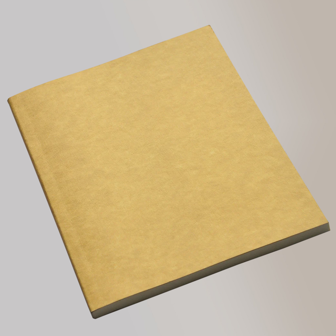 A closed notebook with a paperboard exterior.
