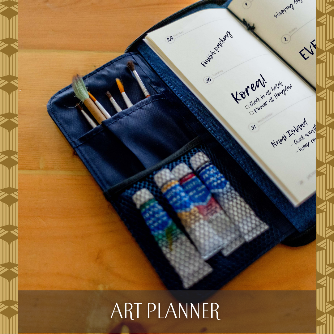 A journal inside a wallet that has compartments for paintbrushes.
