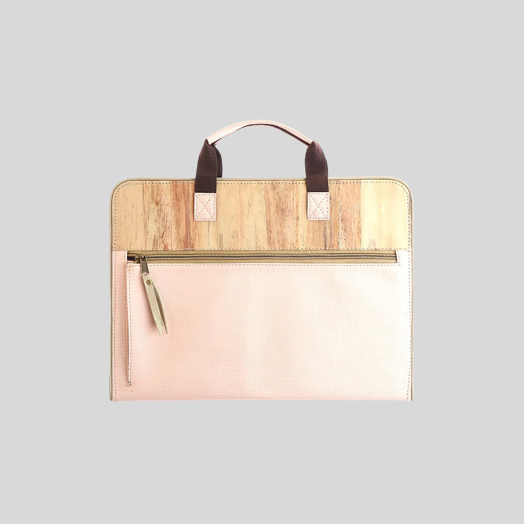 The backside of a vegan leather planner with a built-in zipped pocket made of pink fabric.