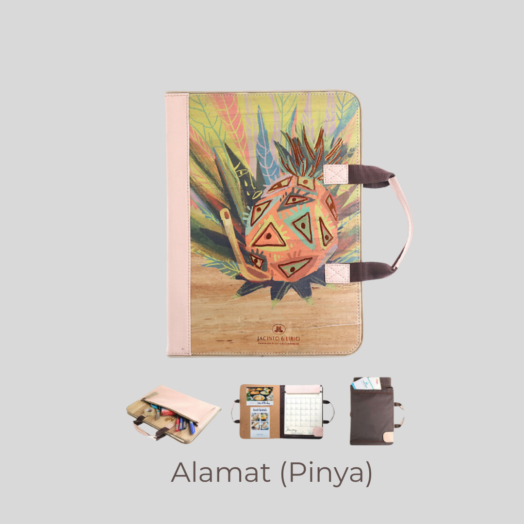 A vegan leather planner with a pink colored spine and handle, with a vibrant illustration of a pineapple on its cover.