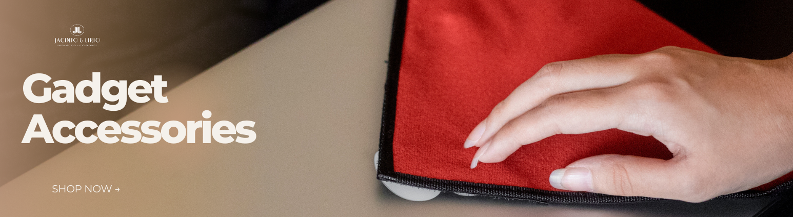 A red square towel over a laptop with a hand resting on it.