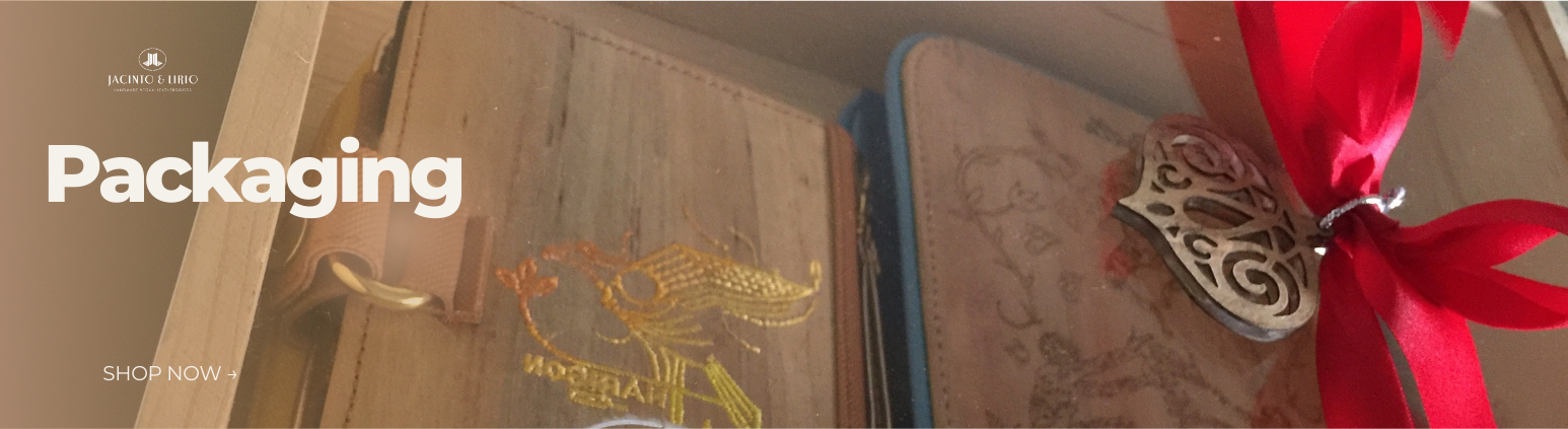 Two journals packaged inside a plastic box with a red ribbon.