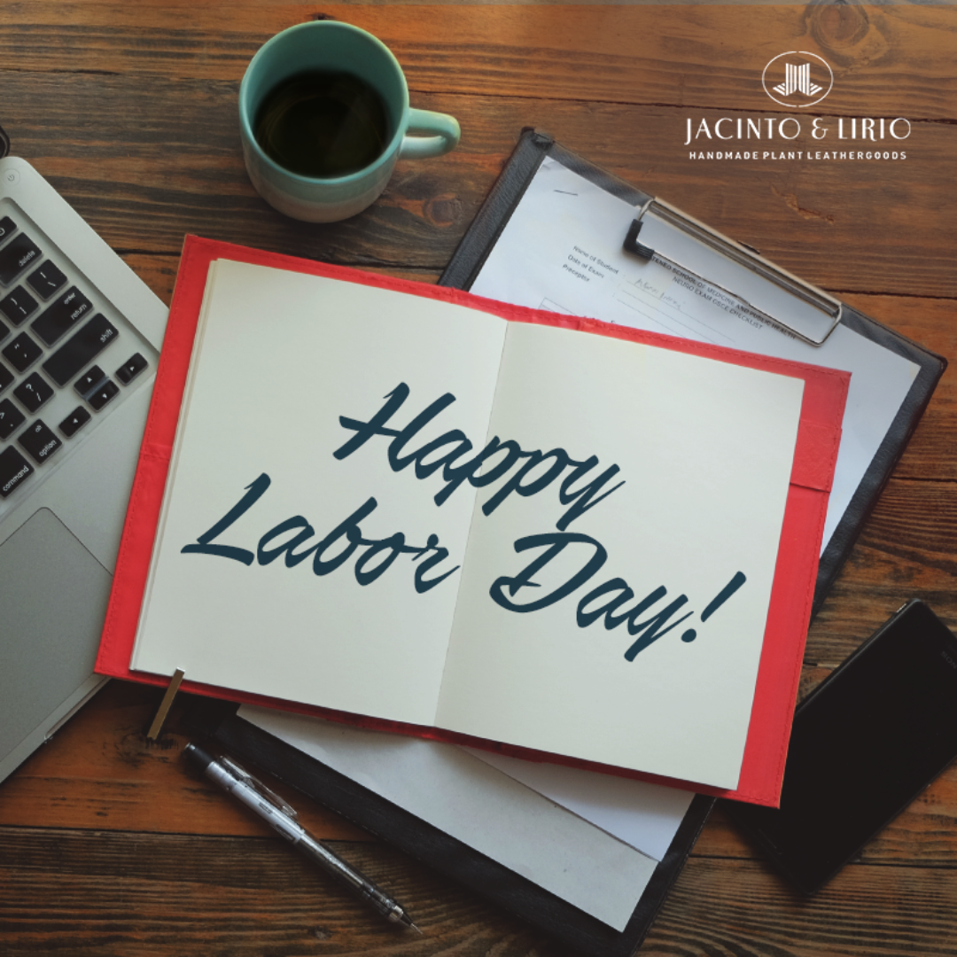 A red notebook opened wide with the message of "Happy Labor Day" written on the pages