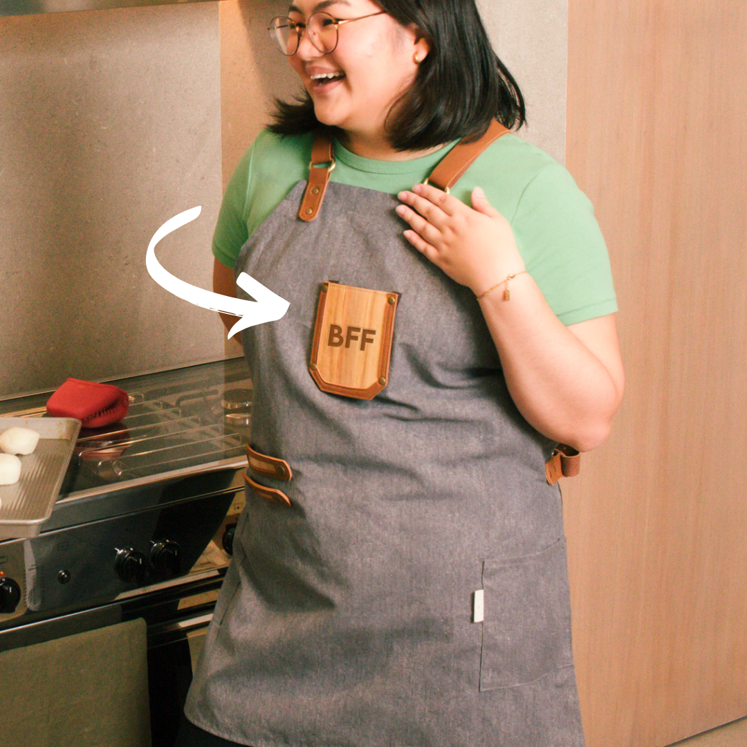 A woman wearing a gray apron with BFF engraved