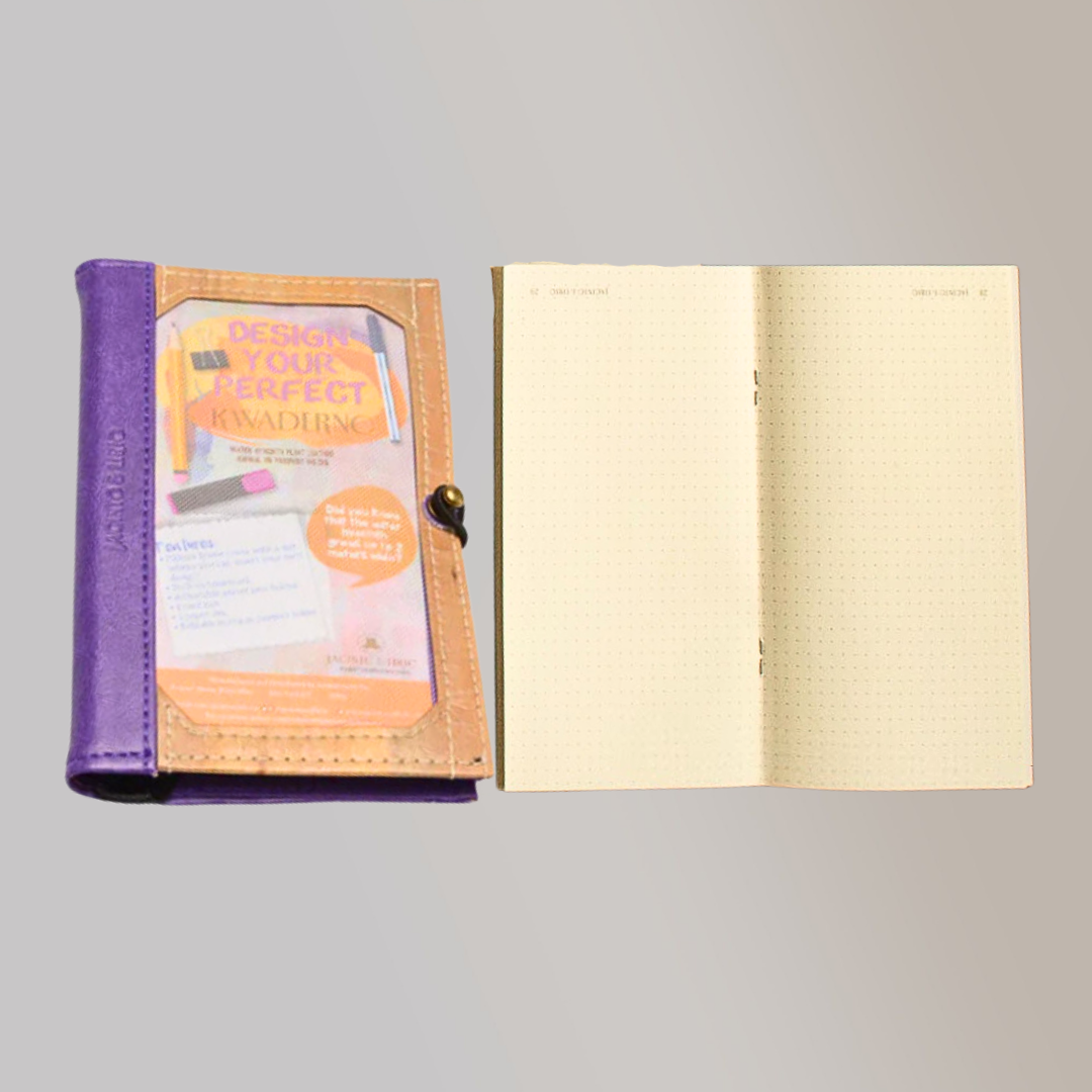 The exterior of a vegan leather journal laying seperate from its notebook pages, which are a detachable refill.