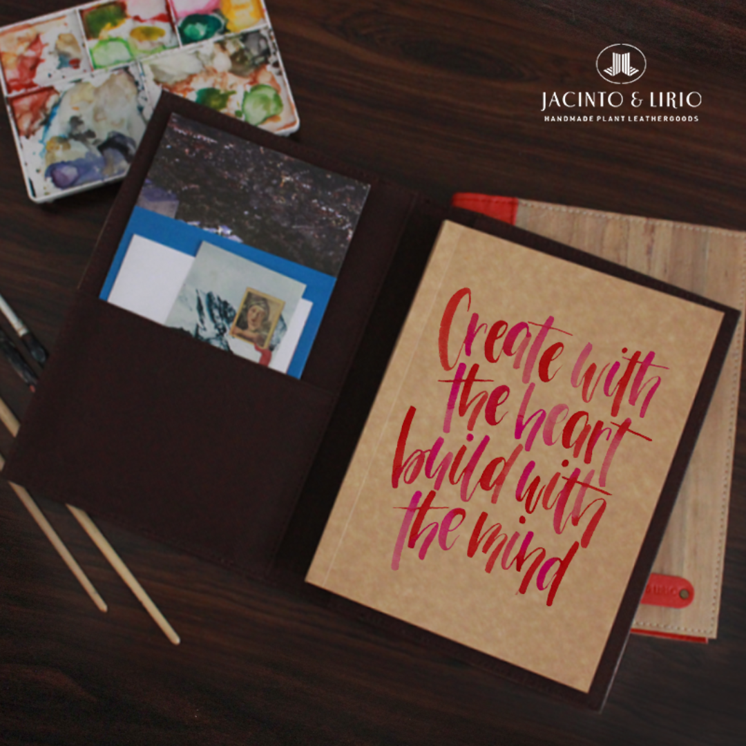 A brown journal with pictures tucked in its inner flap and a calligraphy quote written on its pages.