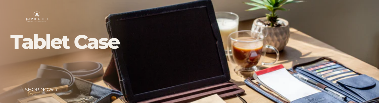 An iPad in a black tablet case on a desk surface.