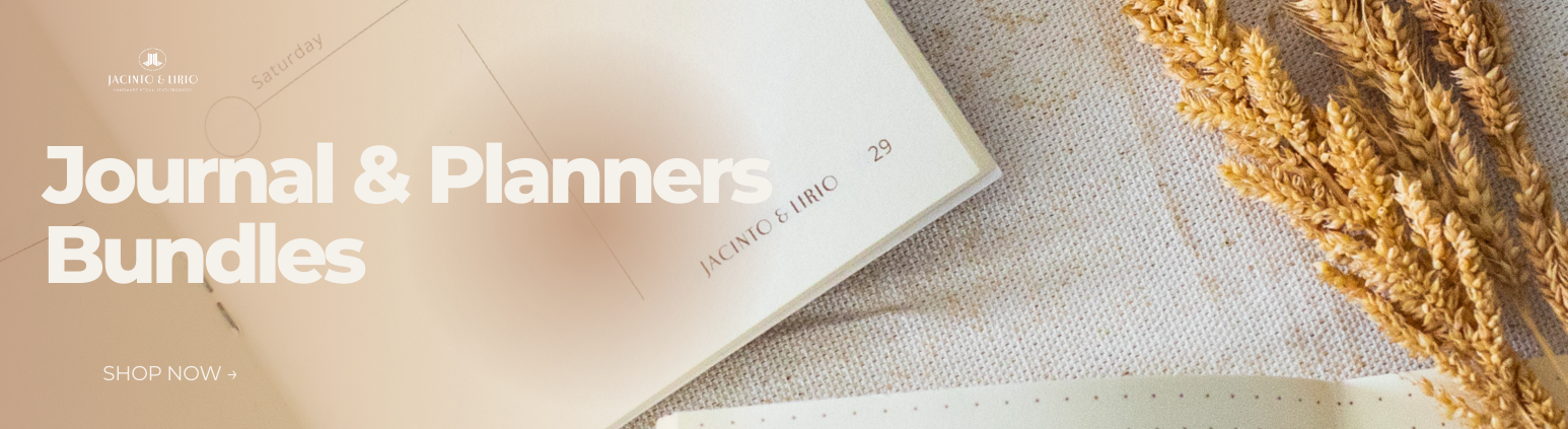 A planner next to grains of wheat on a table surface.