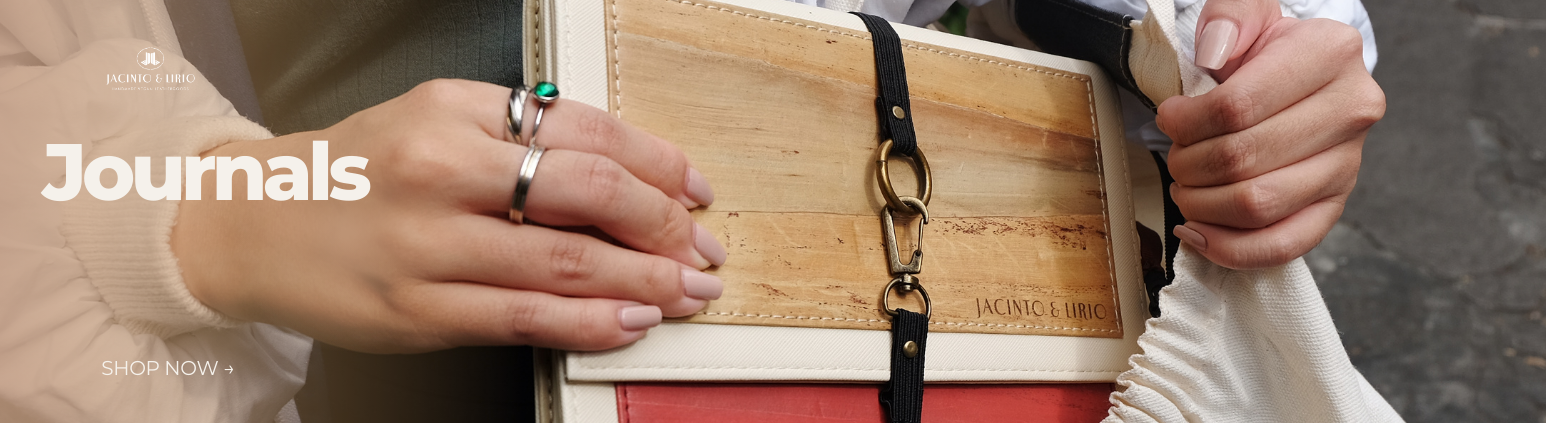 A clasp closure notebook being tucked into a white tote bag.