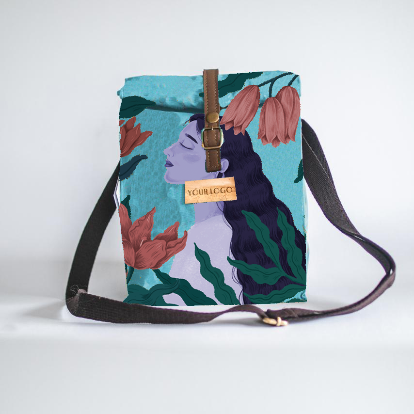 Lunch bag with water hyacinth vegan leather accents and an artwork of a woman with flowers on its water-repellant exterior.