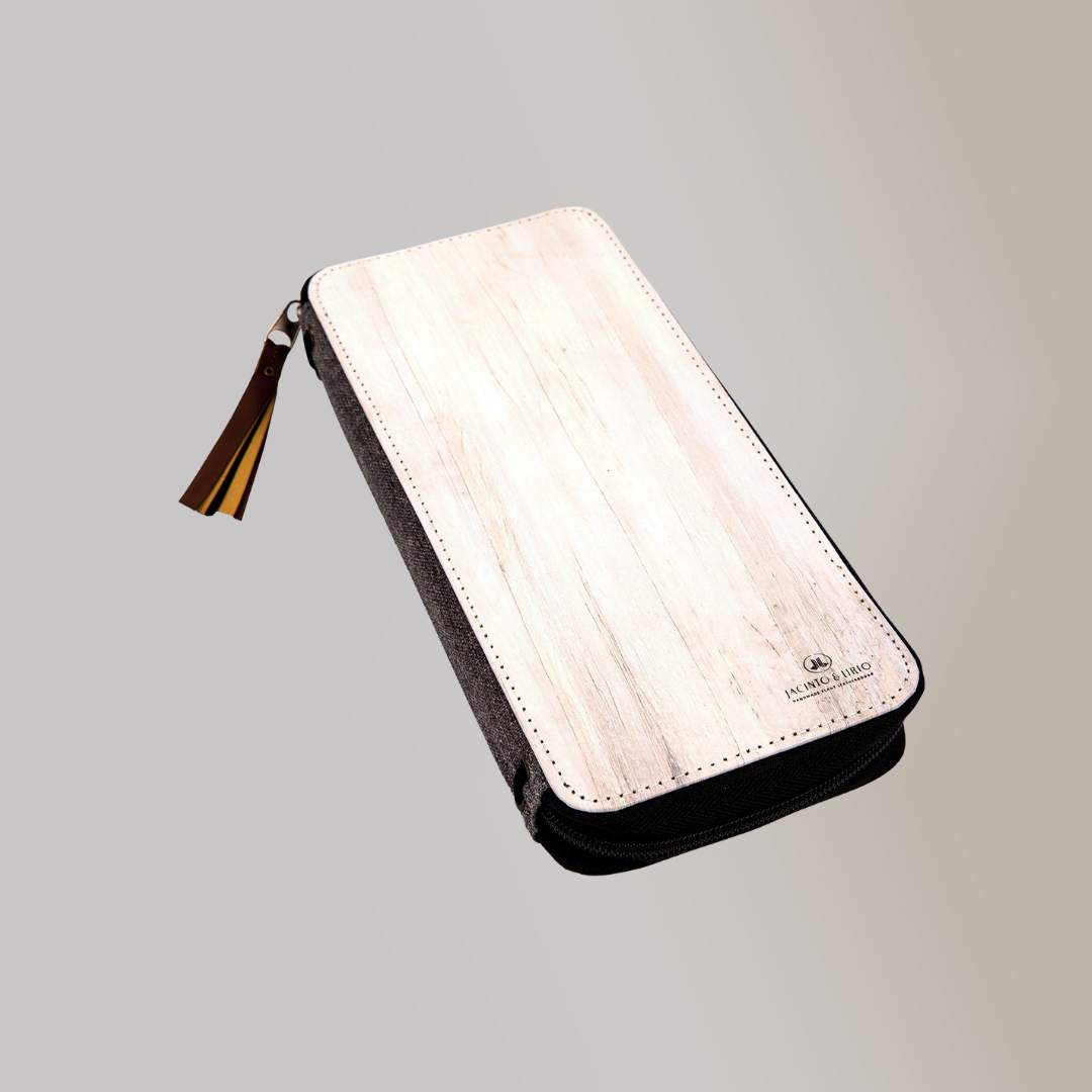 A pale off-white vegan leather zipped planner that has an almost wood-like design on its cover.