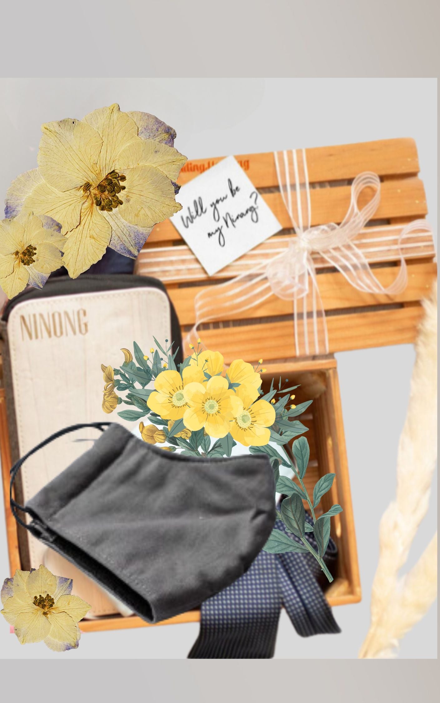 A gift set inside a wooden crate containing: a pastel pink travel wallet and notebook, and a coal gray fabric mask, along with yellow flowers and blue ribbons for decoration.