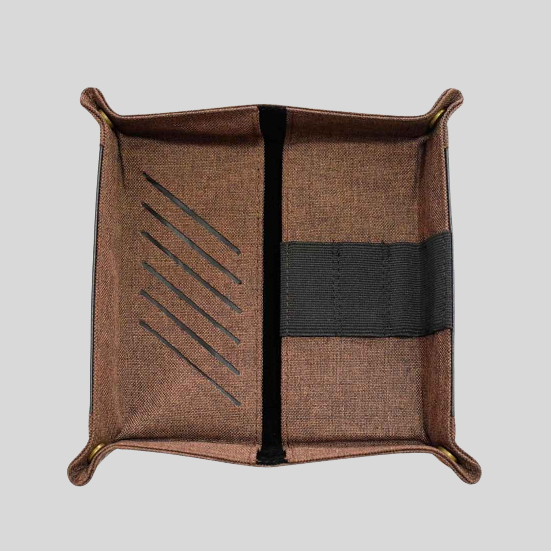 A brown fabric square tray that is perfect for bed-side items such as glasses and a phone.