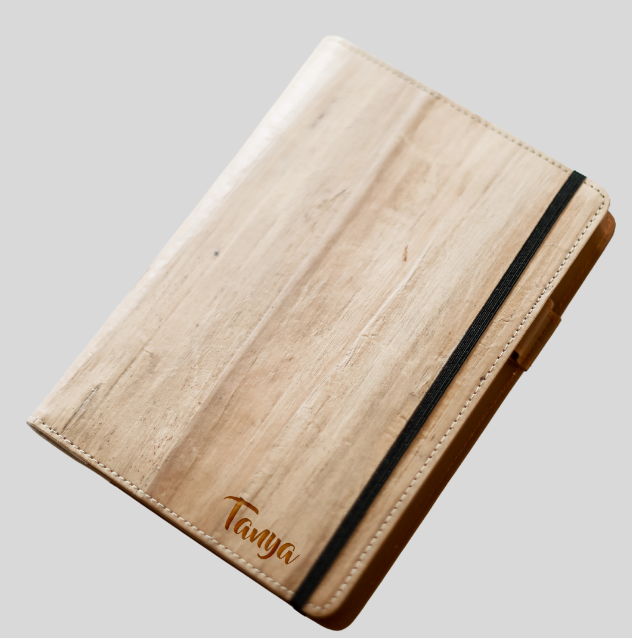 A vegan leather notebook with an engraved name