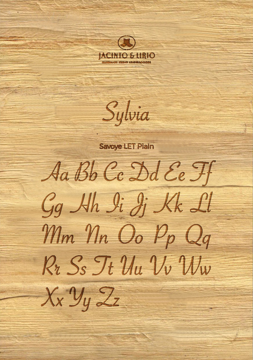 The name "Sylvia" laser engraved on a piece of vegan leather along with its the uppercase and lowercase alphabet engraved with the same font to showcase the full range.