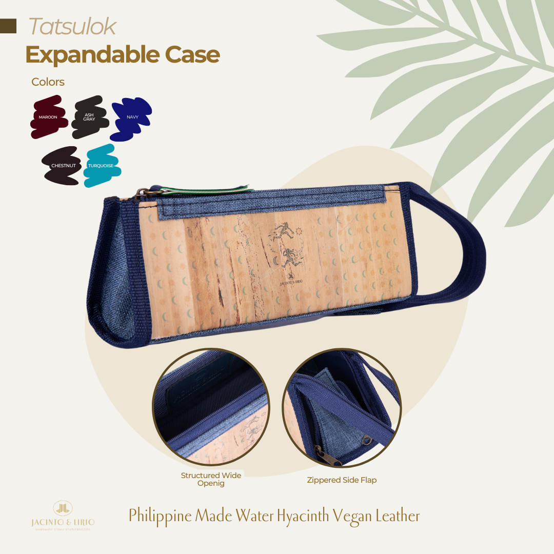A navy triangular pencil case that is expandable and has a vegan leather exterior.