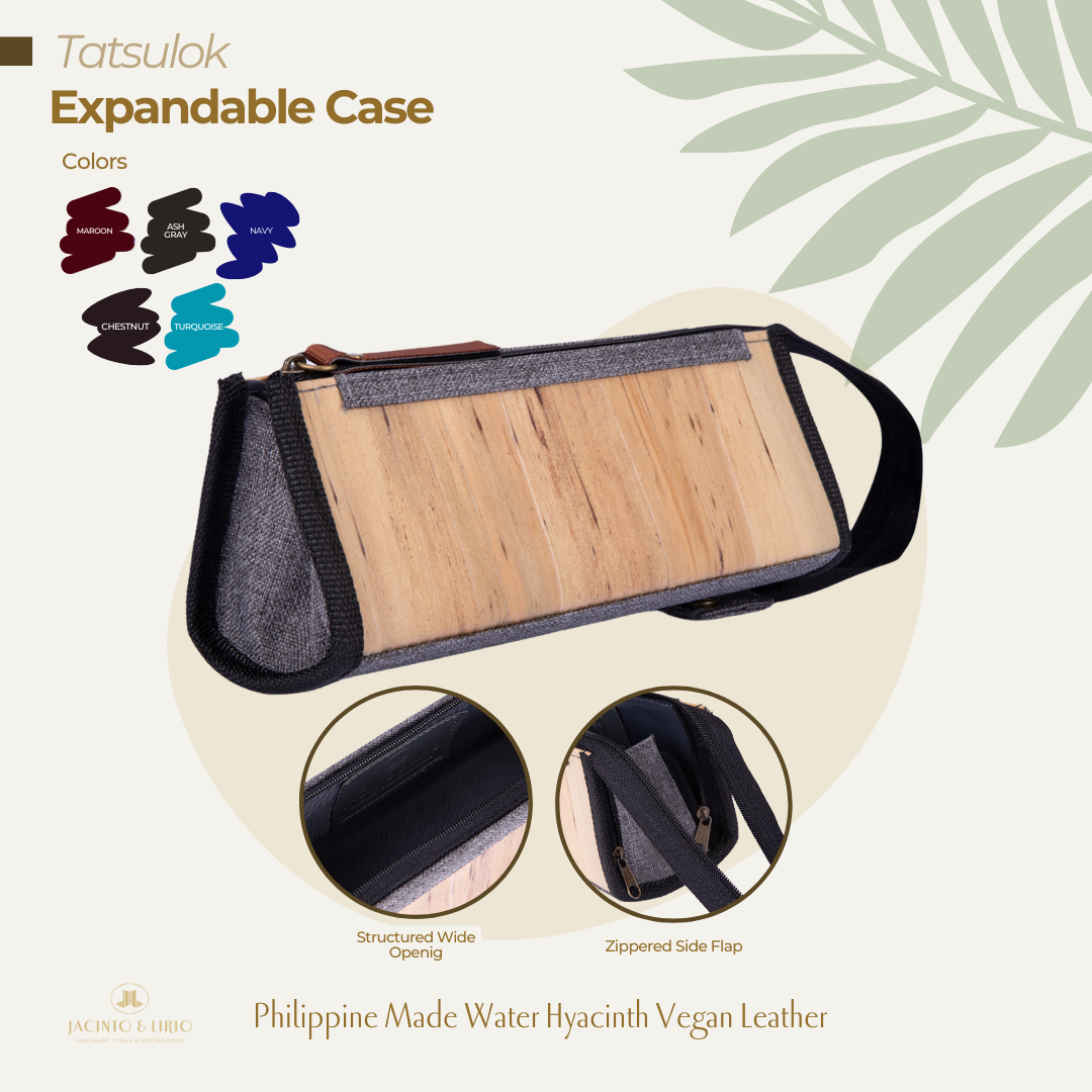 An ash gray triangular pencil case that is expandable and has a vegan leather exterior.