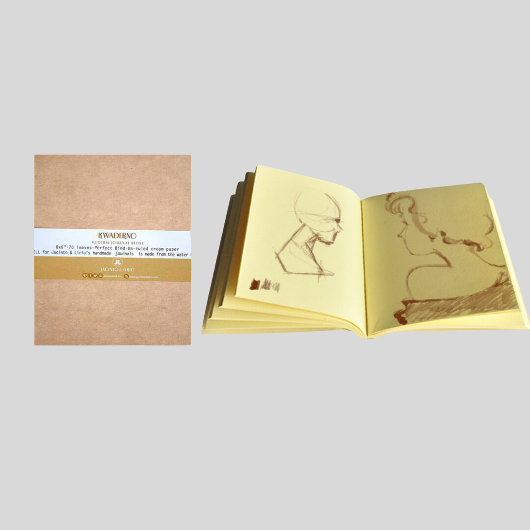 An opened cream-page notebook with pencil sketches drawn on the pages.