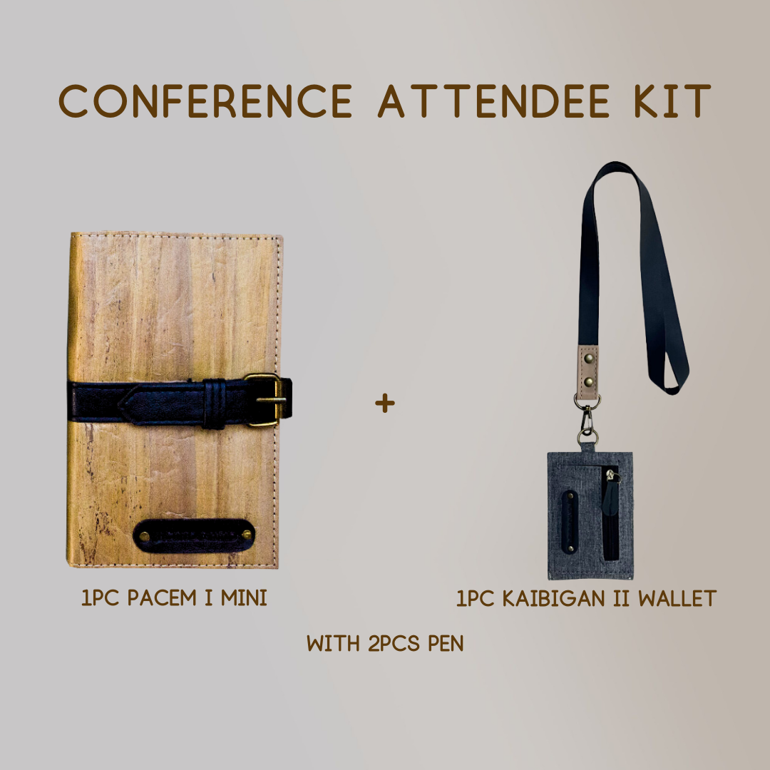 A mini vegan leather journal with a black leather belt buckle closure paired with a wallet ID lanyard of the  same color scheme, and two pens.