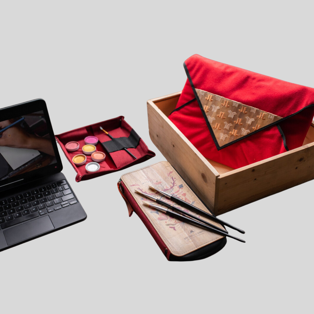 An iPad showing a youtube tutorial for painting which is about to be painted on the cover of a vegan leather wallet with tiny brushes and a small pallette of paint.