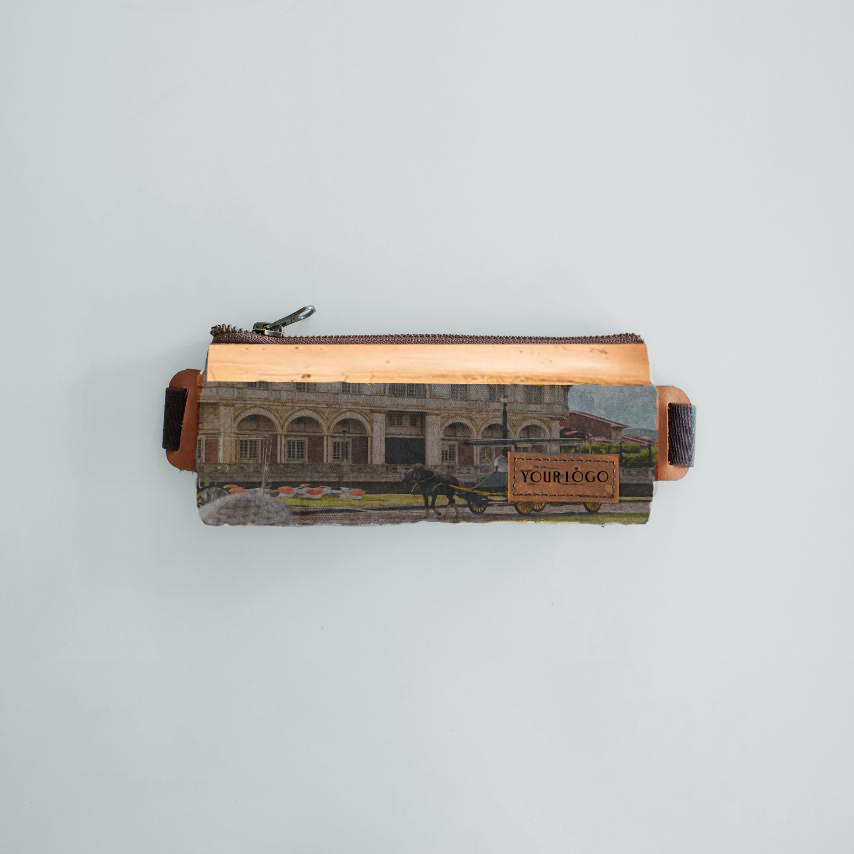 A rectangular pencil case made out of vegan leather, with a design of an 19th century building on it.