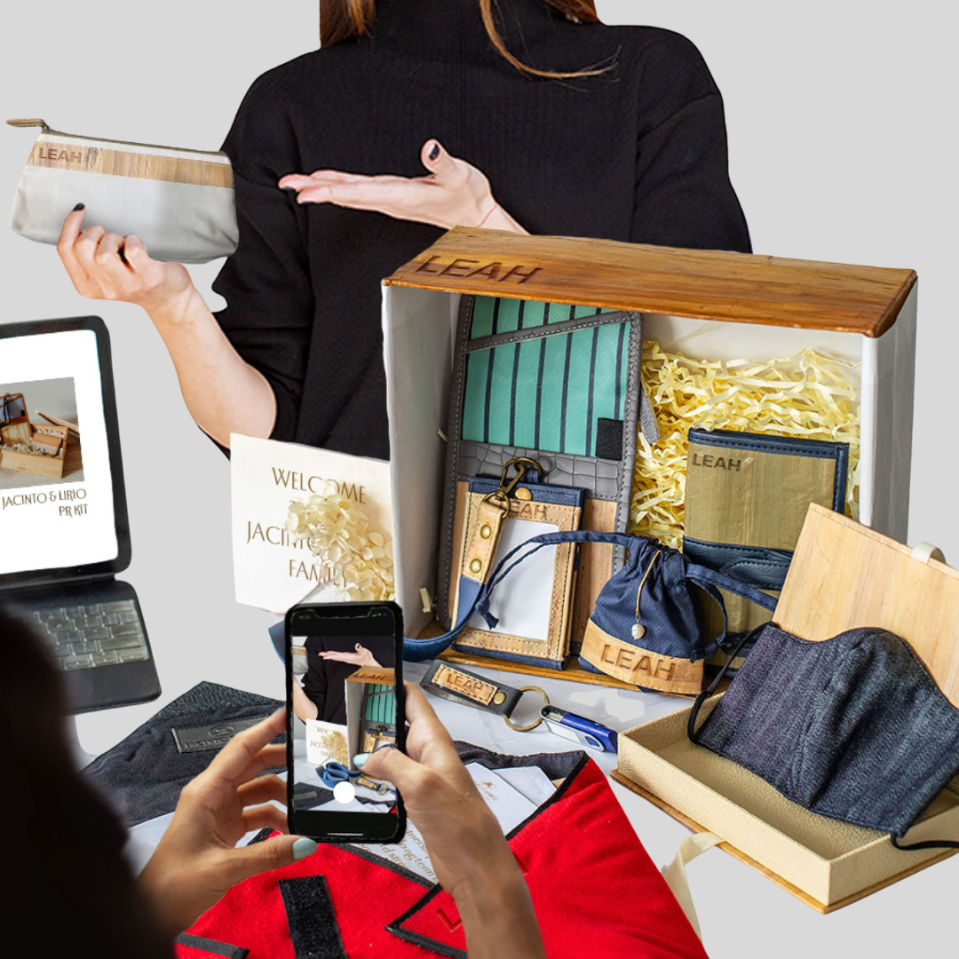 One woman taking a picture of a vegan leather product kit in an upright box, while another woman is showcasing each individual product.