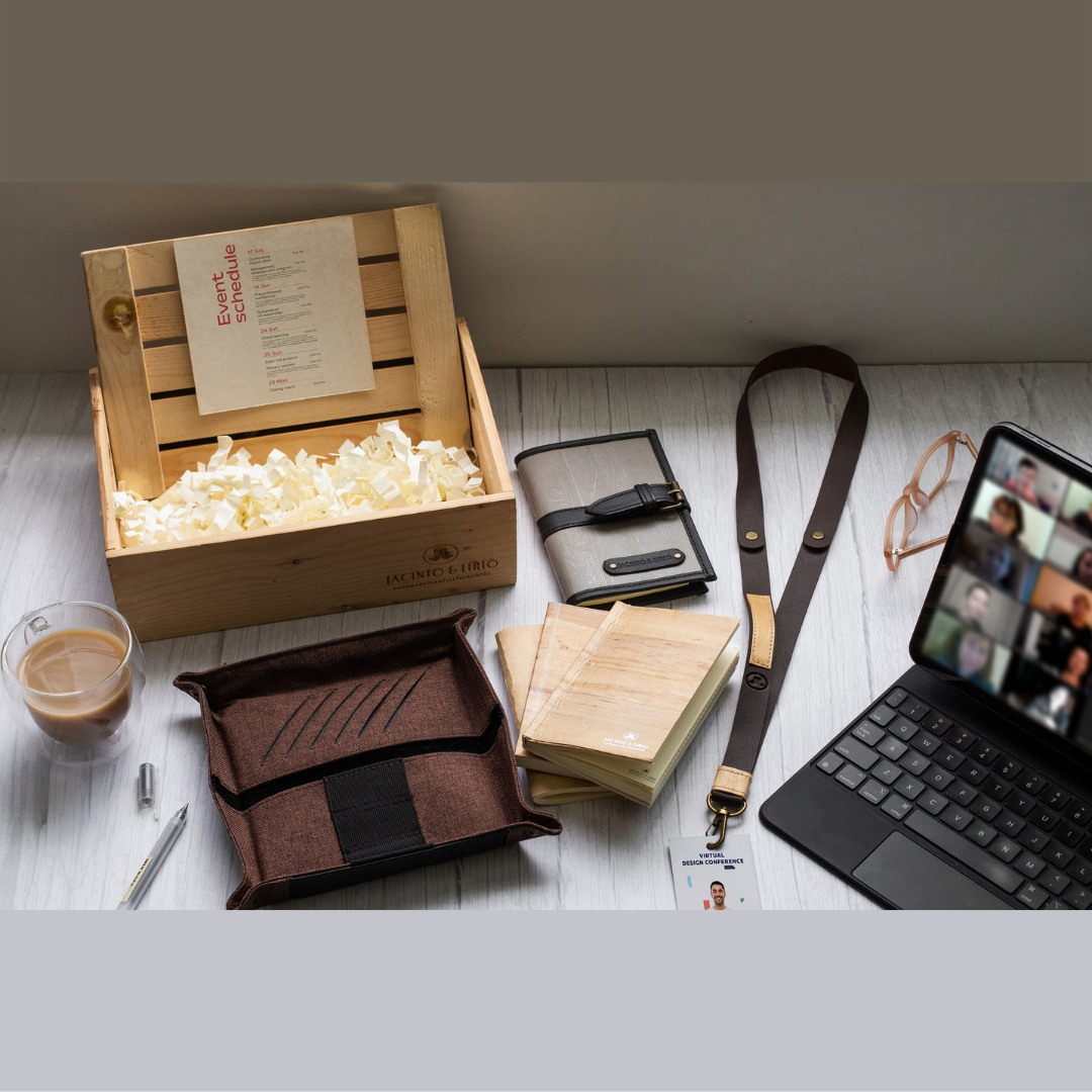 A zoom meeting opened on iPad beside a brown vegan leather tray and ID lanyard.