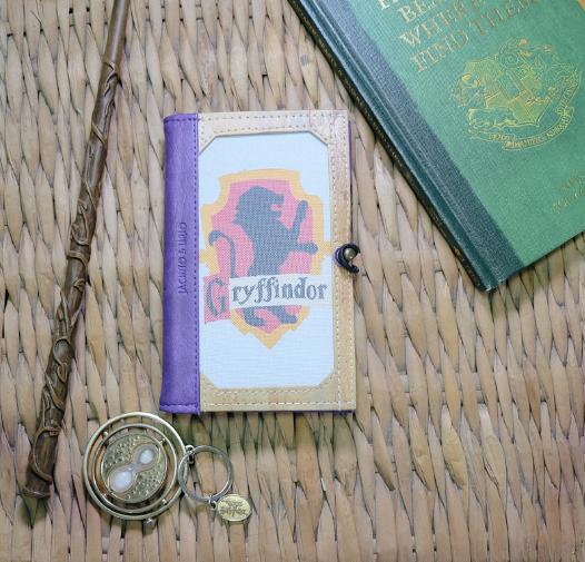 Showcasing the Pinto Mini Passport Holder's versatility with a Gryffindor house theme, featuring the iconic lion symbol as the customizable cover design.