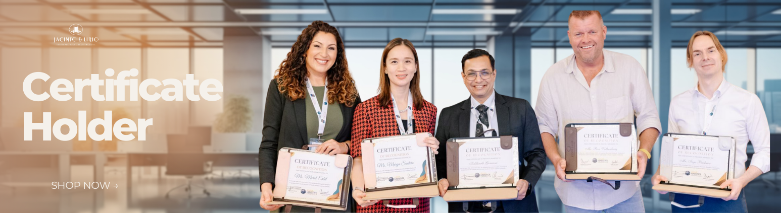 A diverse group of five adults, holding certificate frames, stand in a modern office setting. Each person smiles at the camera. The background shows large windows and office furniture.