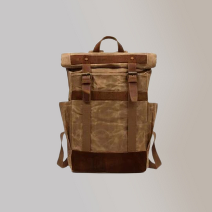 A earthy brown monochrome backpack made of vegan leather and suede material, with two closing belt buckle straps and spacious interior.