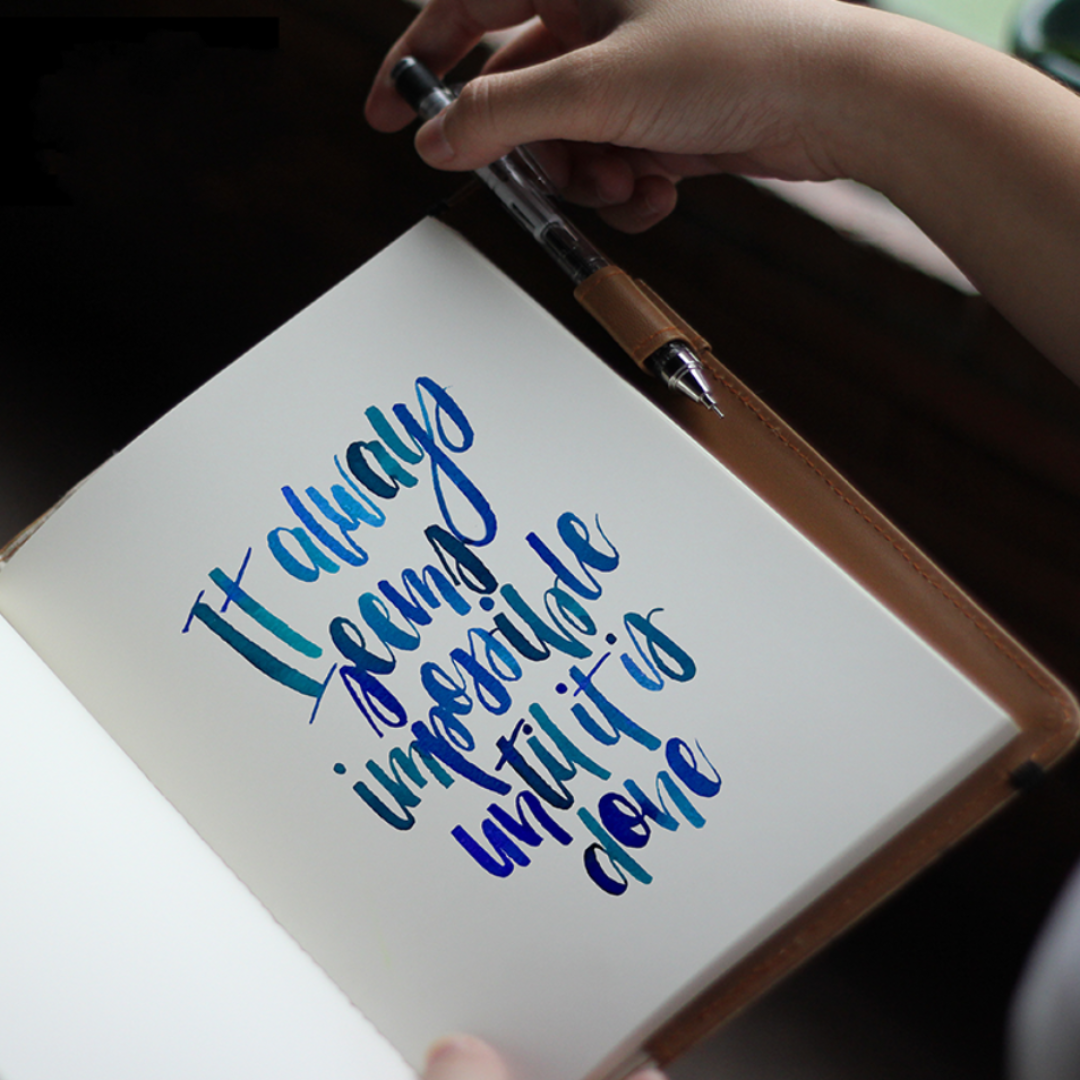 A calligraphied quote on a white paged book.
