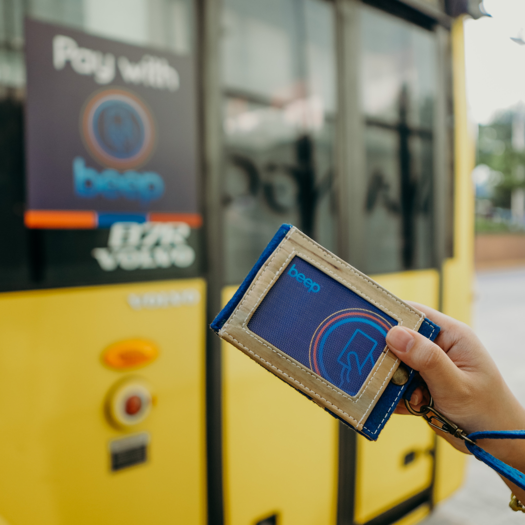 A transport card inside of a blue vegan leather lanyard.