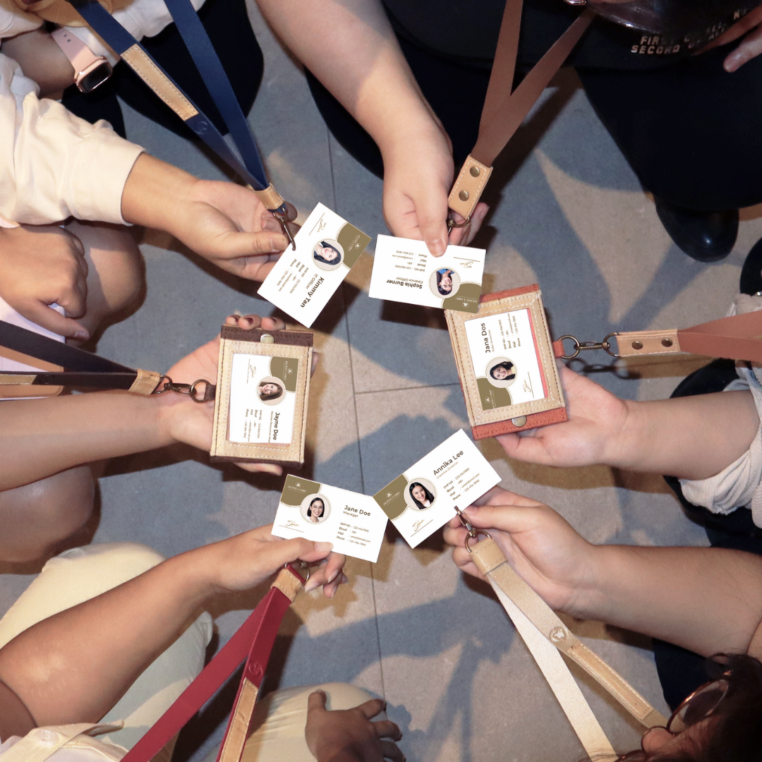 People in a circle showing off their vegan leather lanyards.