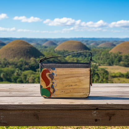 Gala Chocolate Hills on a wooden surface with a scenic background of the Chocolate Hills and a blue sky.