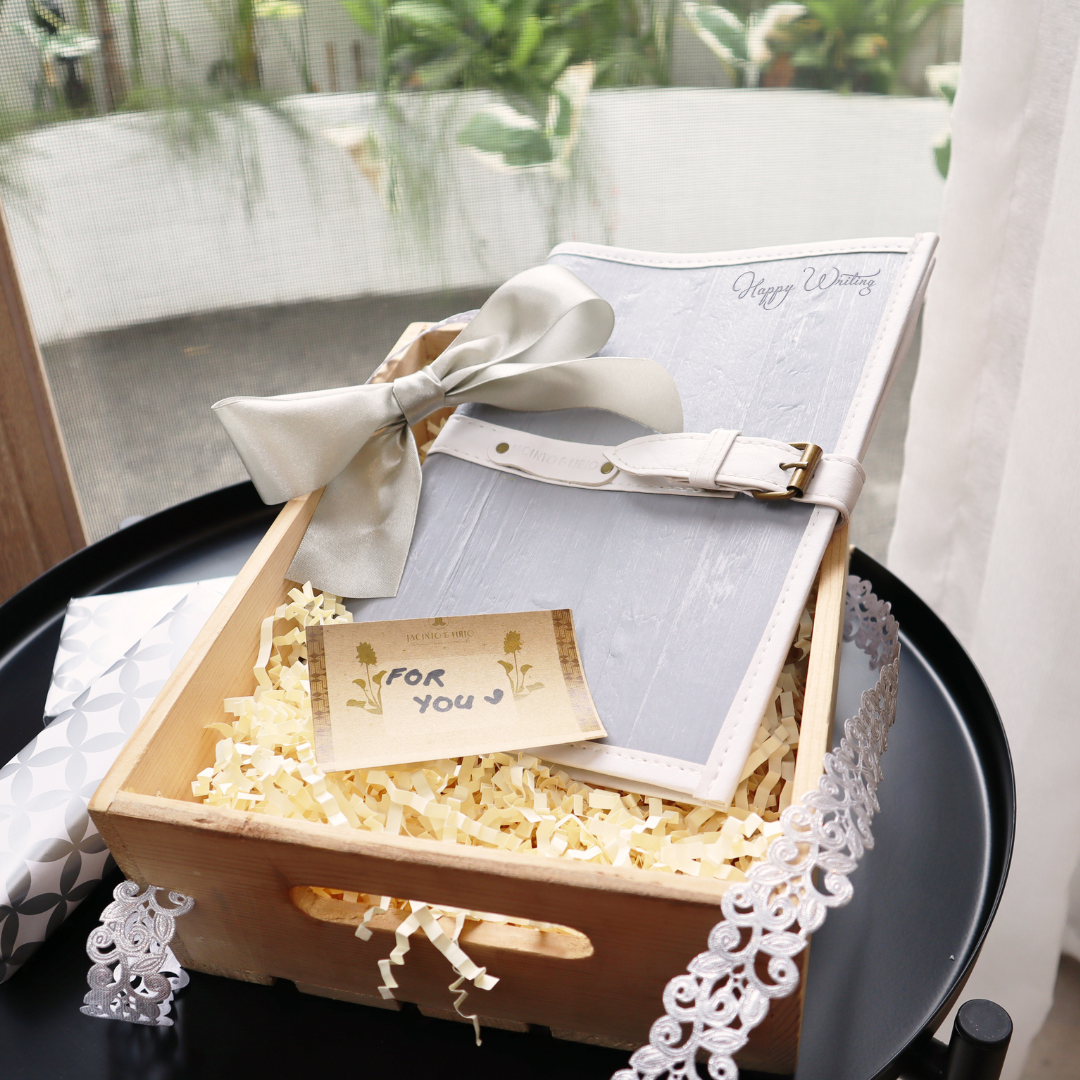 A cool white vegan leather journal in a box.