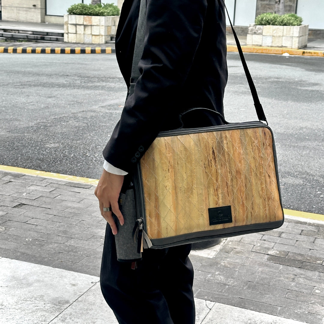 Businessman holding a Hiraya bag with Tatsulok on a street.