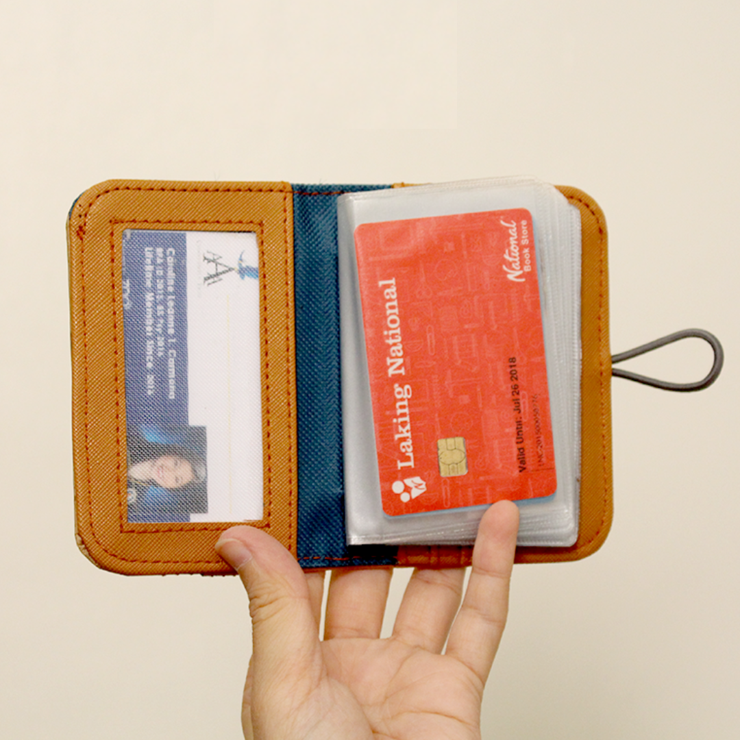 A orange leather card wallet with many cards.