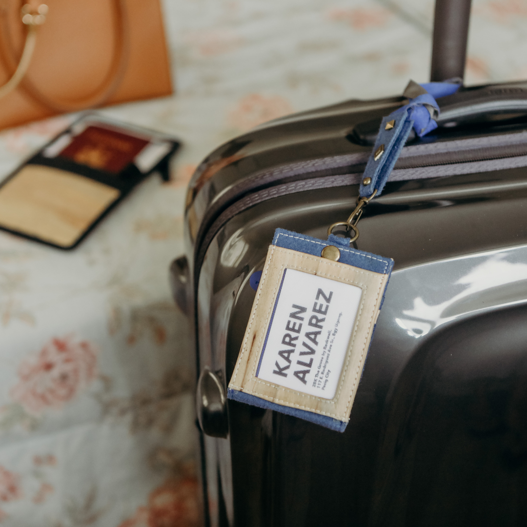 A blue ID holder being used as a luggage tag.