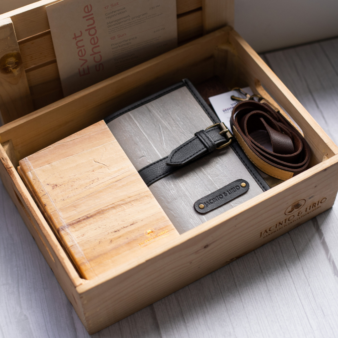 A wooden box filled with vegan leather goods.