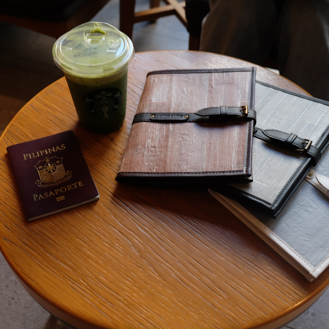 Two vegan leather journals on a wooden table.