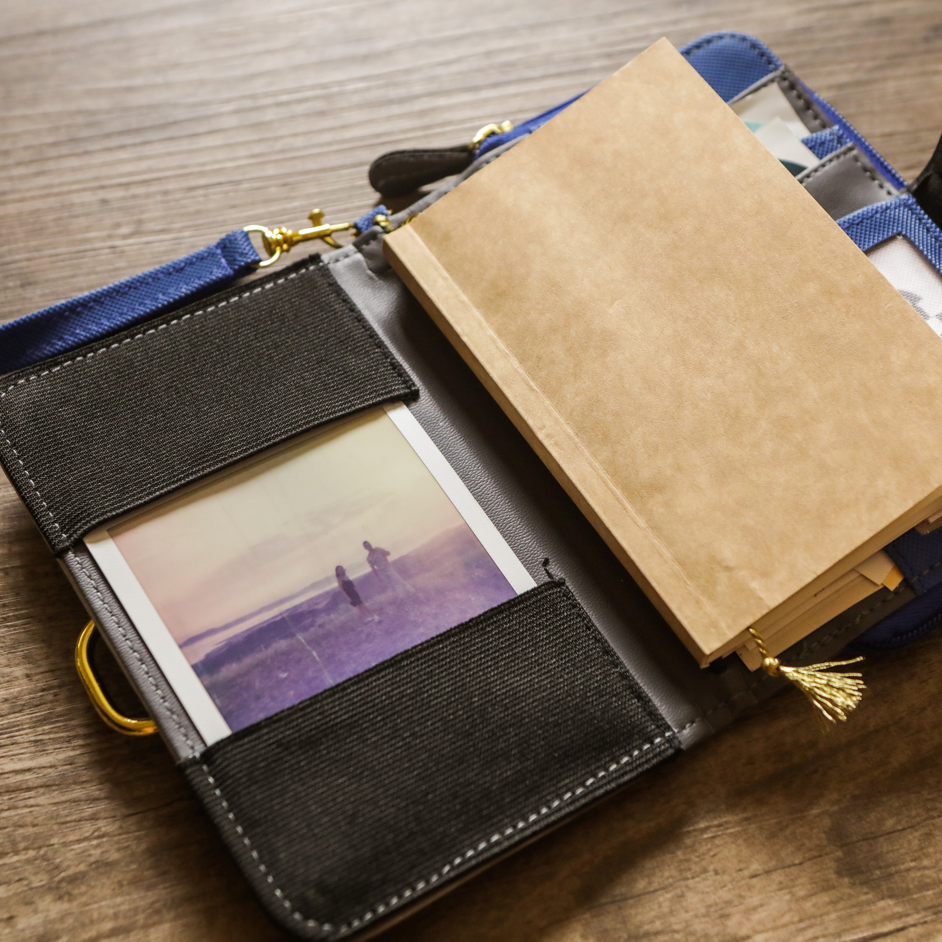 A brown kraft page insert inside a blue and black journal sleeve.