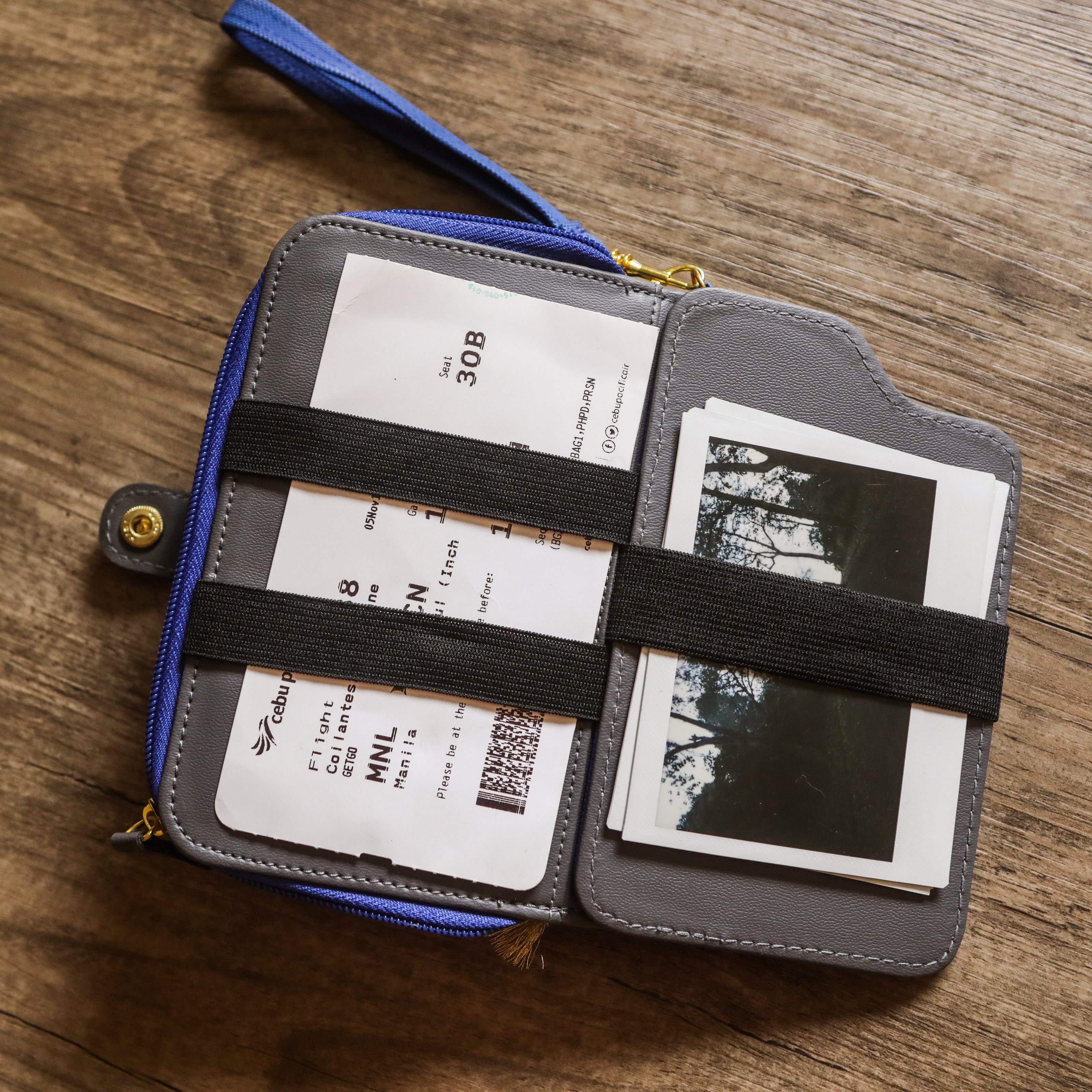 A milkman's wallet that holds polaroids and a boarding ticket.