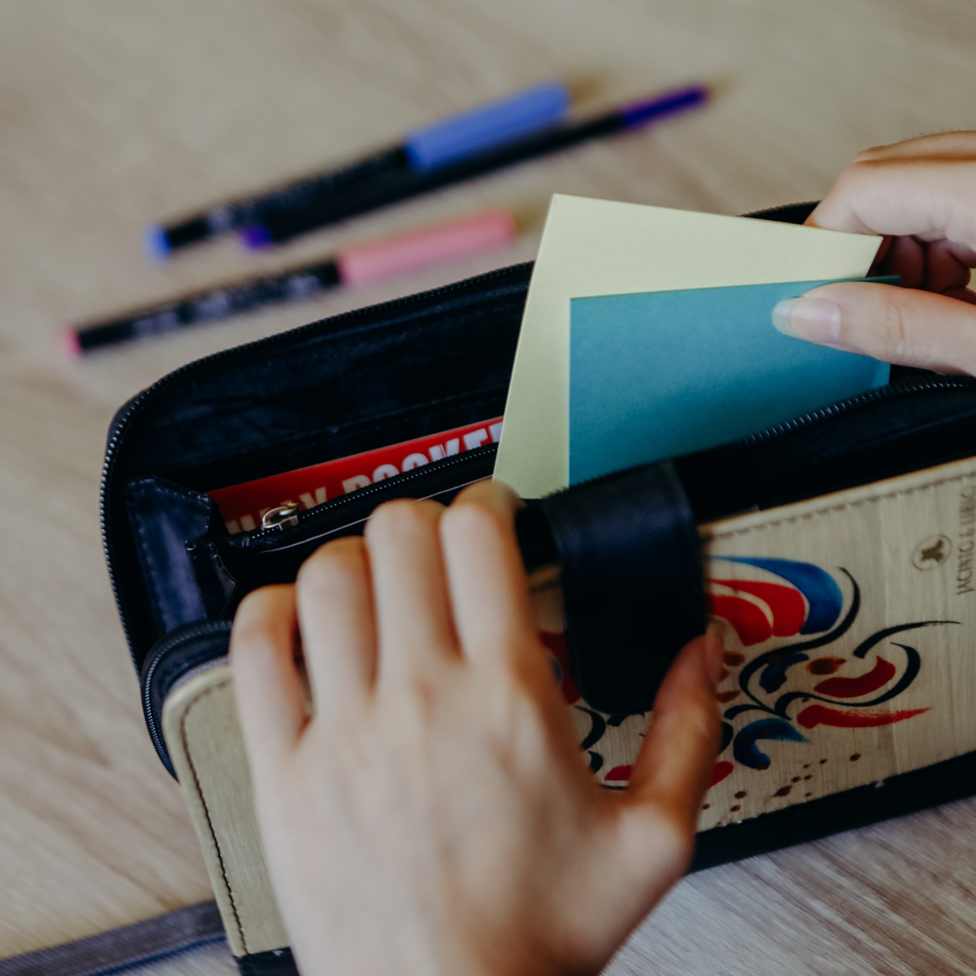 Pieces of paper being stored inside a journal wallet.